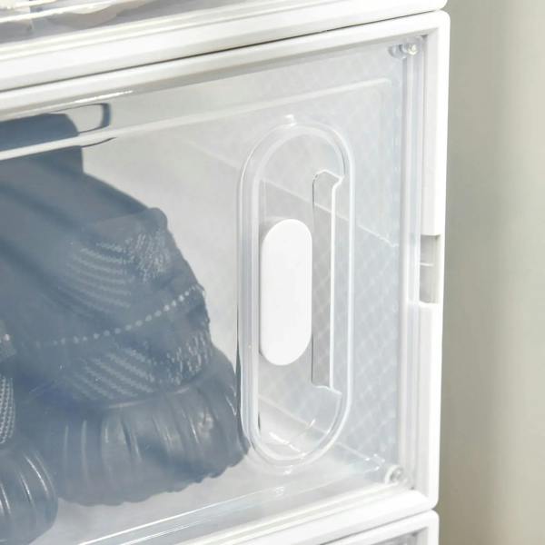 Close-up clear magnetic door on plastic shoe storage box with integrated handle