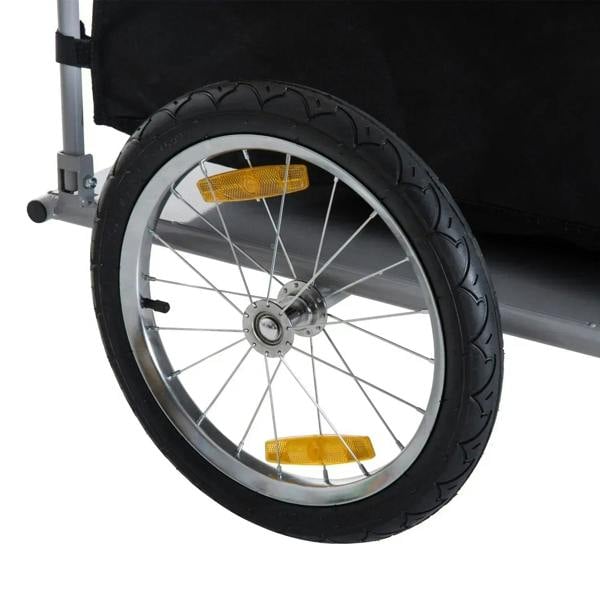 Cargo trailer wheel with yellow reflectors, silver rim, and black tire