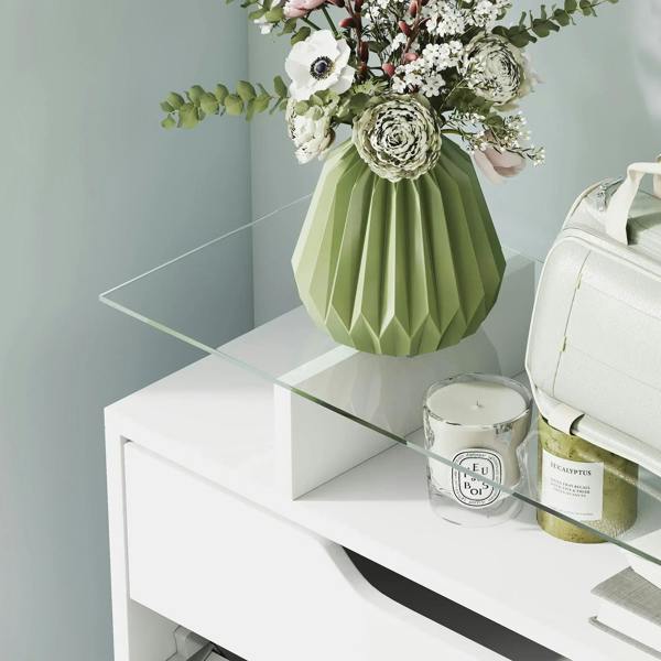Tempered glass top on a white shoe storage cabinet with raised shelf edge