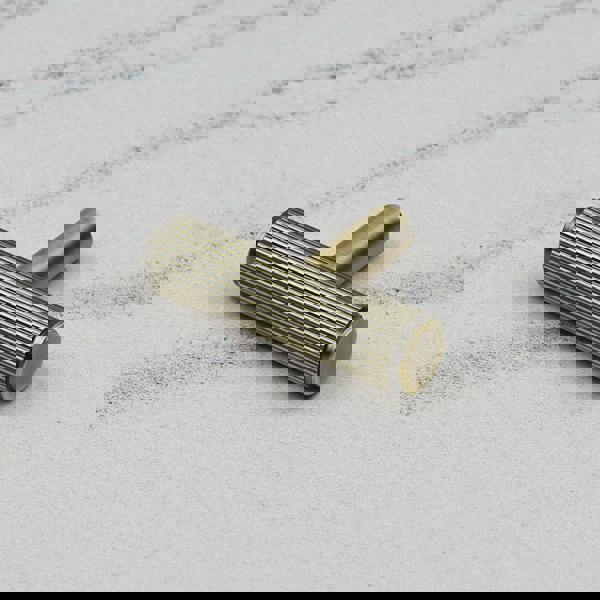 An antique brass reeded T-bar