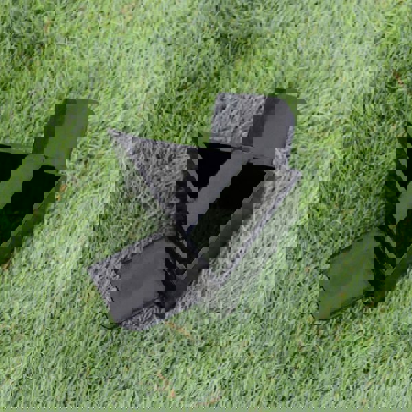 Black steel log splitter attachment with triangular and rectangular shapes, designed for the T-Mech 5T Log Splitter, resting on green grass