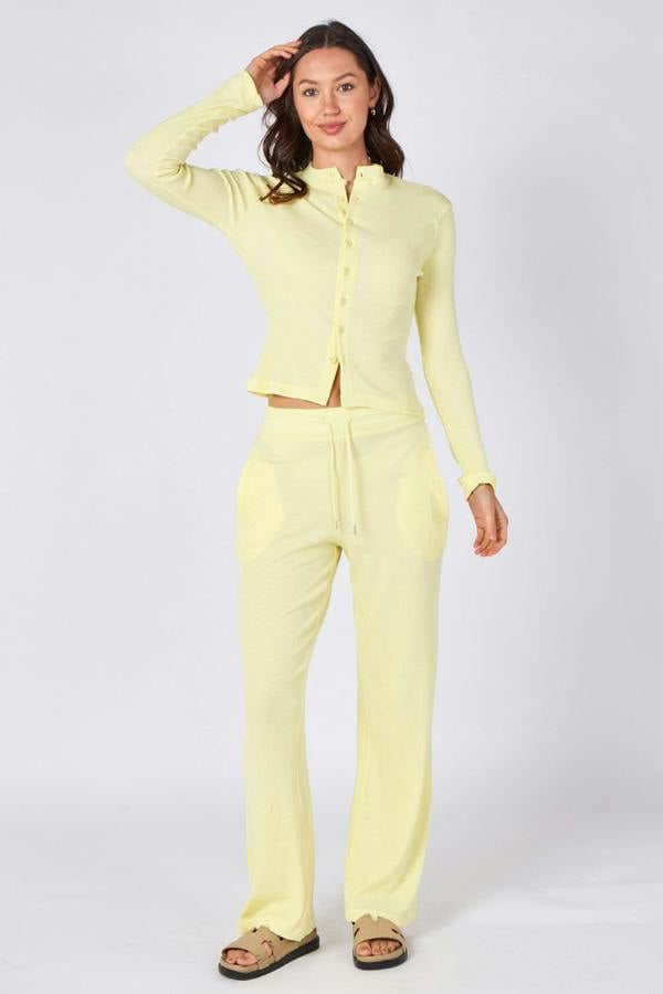 Woman wearing a light yellow outfit on a white background