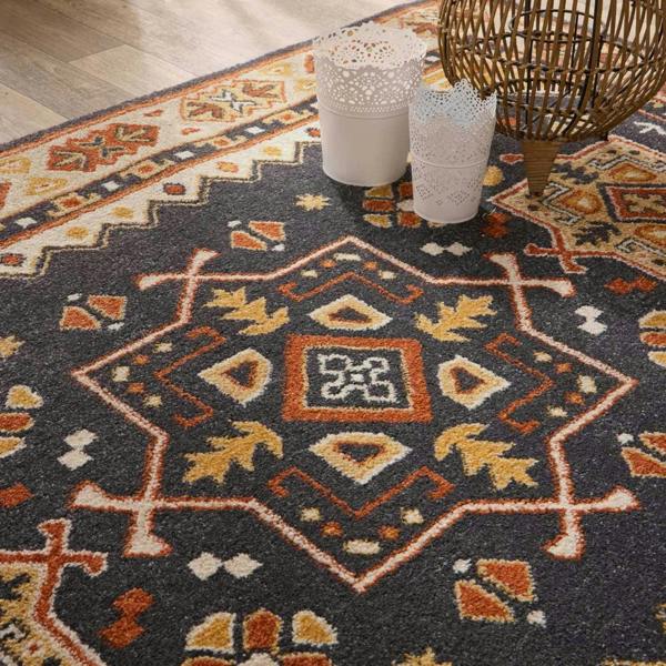 Decorative rug with intricate patterns on a wooden floor.