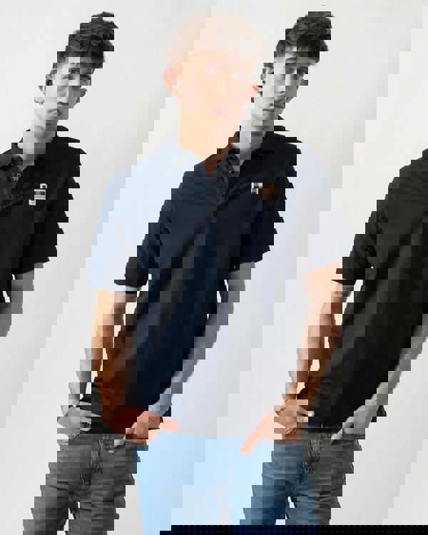 Studio shot of a model wearing an Aquascutum Mens Stretch Piquet Badge Polo Shirt in Navy 11