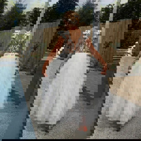 Pretty girl stood around pool