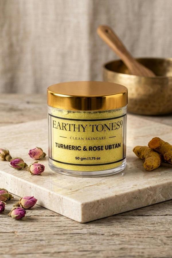 Earthy Tones 9 Turmeric & Rose Ubtan (facemask) on a marble slab with turmeric roots and rose petals.