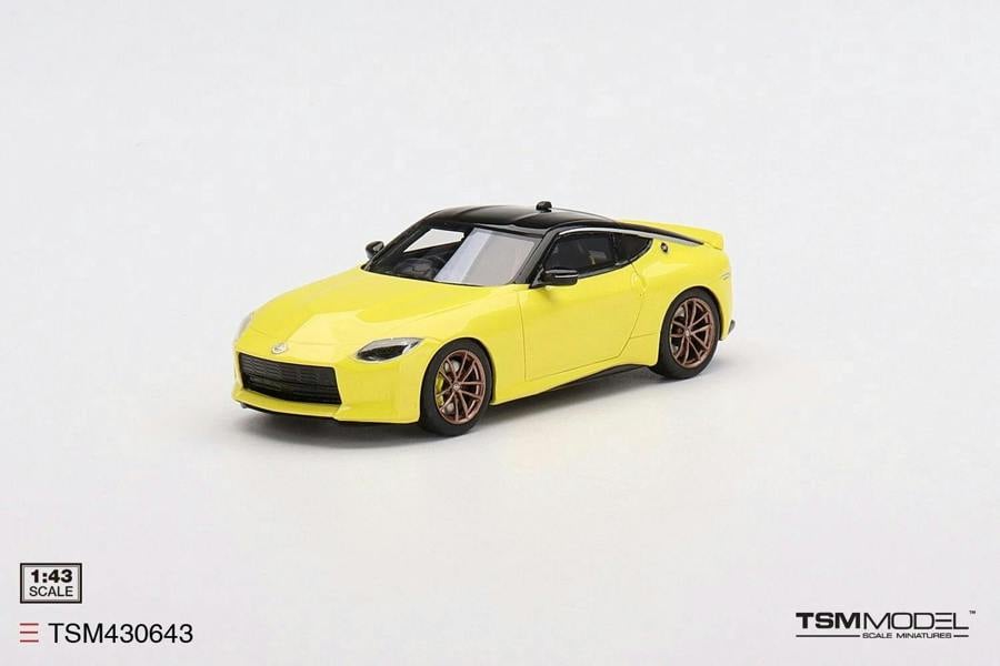 a yellow toy car on a white background