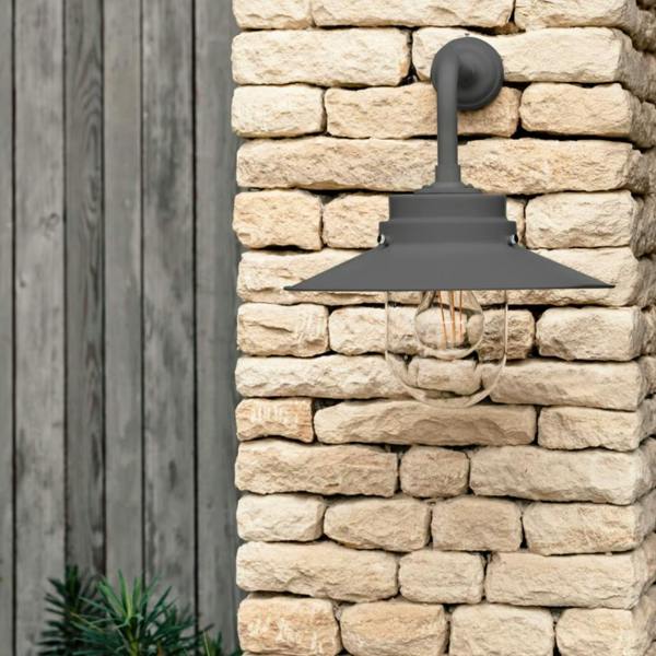 HMS Belfast inspired Carbon deck light mounted on a light stone wall.
