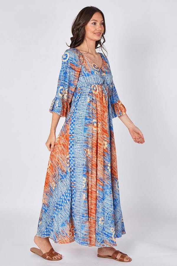 Woman wearing a colorful patterned dress on a white background