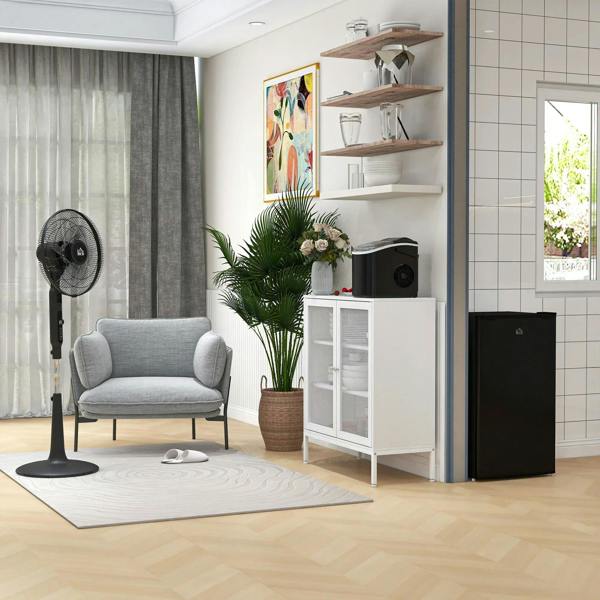 Black compact mini refrigerator with closed door for under-counter placement