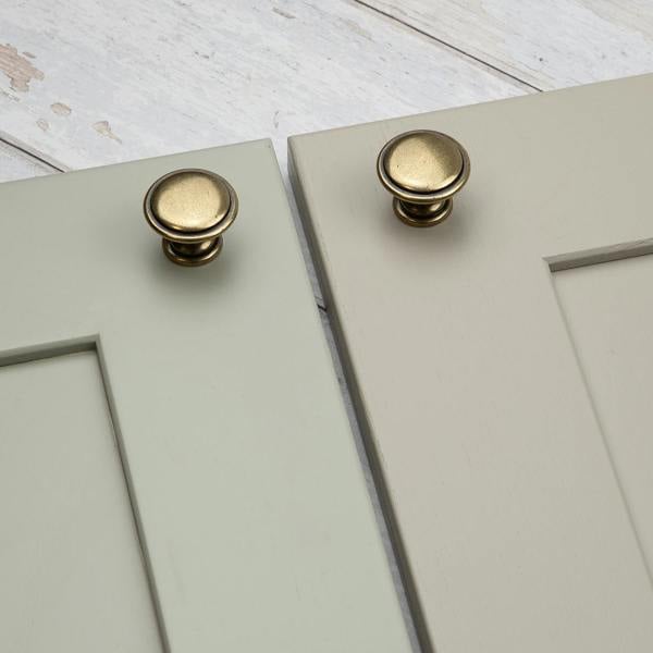 An antique brass round circular cabinet knob 