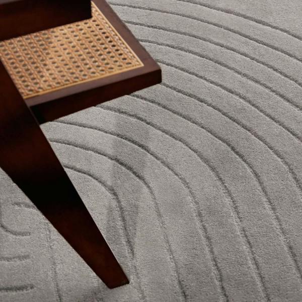 Gray textured carpet with a wooden step stool