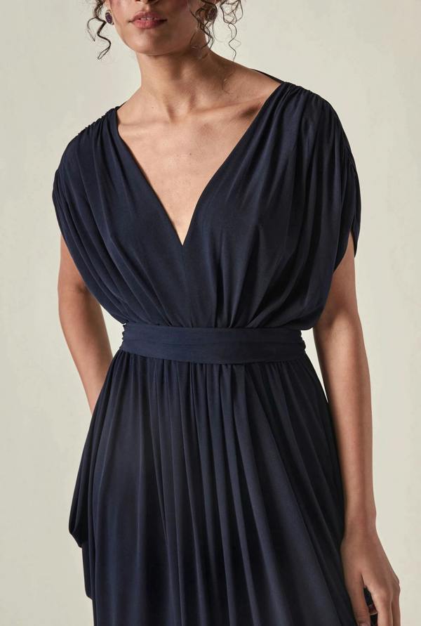 Close up view of the Draped Open-Back Midi Dress in Navy by James Lakeland against a studio background