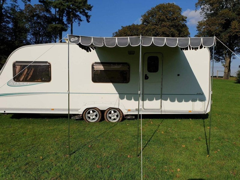 An image of the Charcoal Caravan Sun Shade Canopy from OLPRO attached to a caravan.