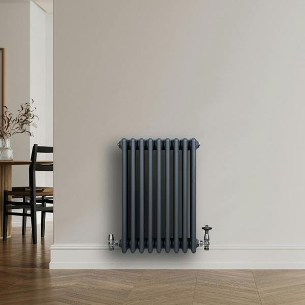 Traditional anthracite grey 4 column radiator with valves, featuring a sleek, textured finish, mounted on a light wall in a modern interior setting