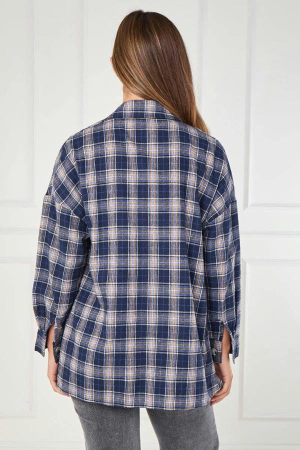 Person wearing a blue and white plaid shirt against a white background