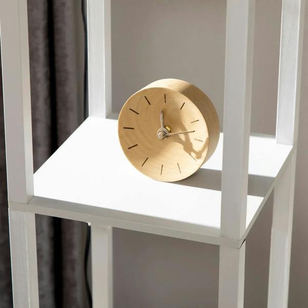 White floor lamp shelving unit with round clock detail on middle shelf