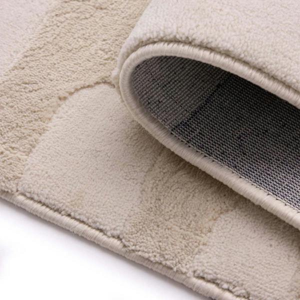 Close-up of a beige textured rug with a white background