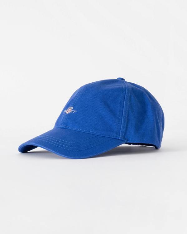 Blue baseball cap on a light gray background