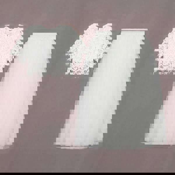 White lace top and tulle skirt on a brown background