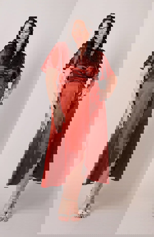 Satin wrap bridesmaids dress in burnt orange with a short sleeve A beautiful rich copper rust colour, this dress is a modern and stylish option for all occasions.