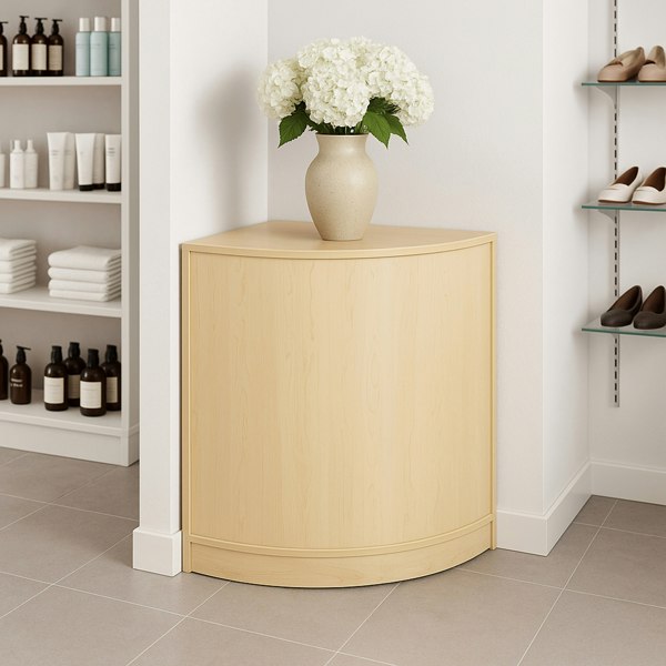 Corner retail shop counter in maple finish, featuring a smooth surface, rounded edges, and a vase of white flowers on top