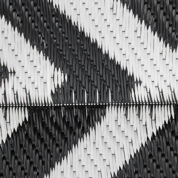 Black and white woven plastic straw rug mat with textured braided surface