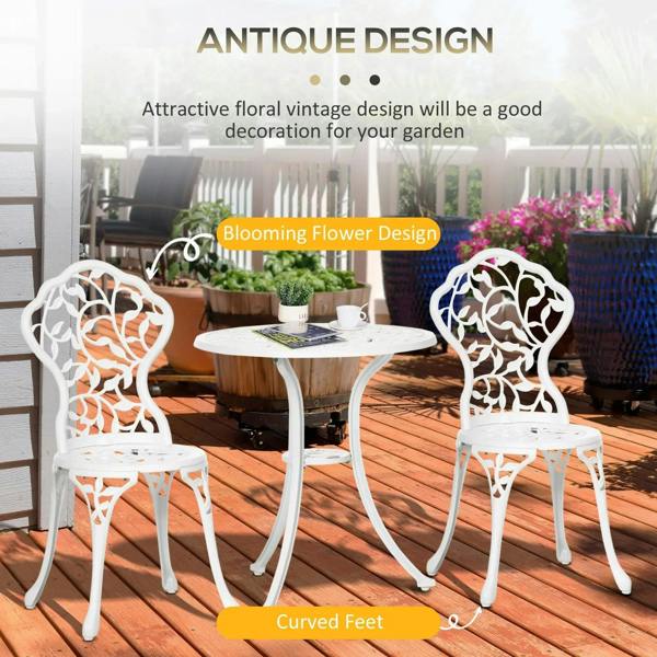 White bistro table with two ornate chairs, floral cutout backs and curved feet