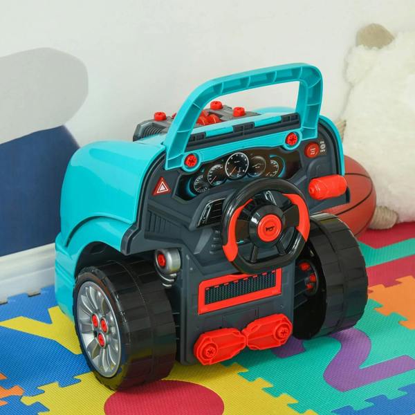 Teal toy car dashboard close-up with steering wheel, horn button, and red engine controls