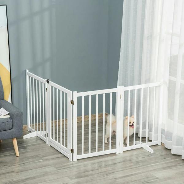 White freestanding pet gate with vertical bars and open entry, keeping pets behind