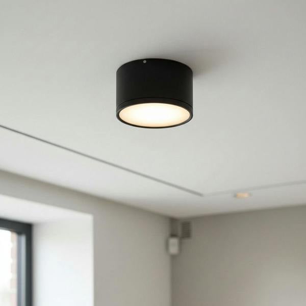 black round LED surface mount light shown on the ceiling in a house