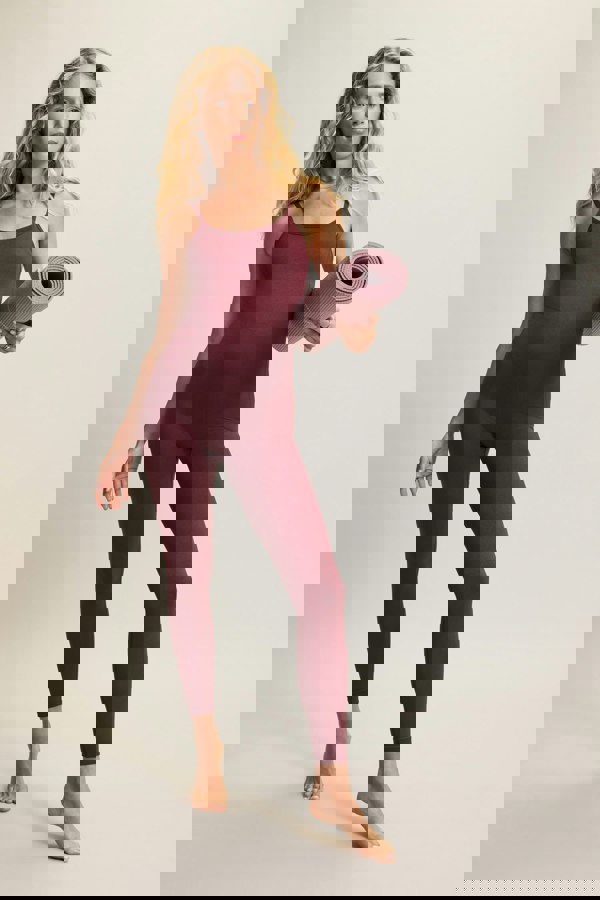 Red burgundy one-piece with adjustable straps, low cross-back design, removable pad and sculpting fit, crafted from recycled polyamide for a secure and flexible fit. Perfect for gym workouts, Pilates, or layering for casual wear.