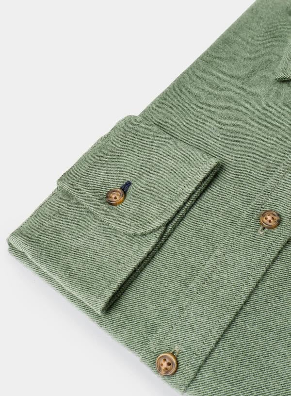 Close-up of a green fabric with buttons on a white background