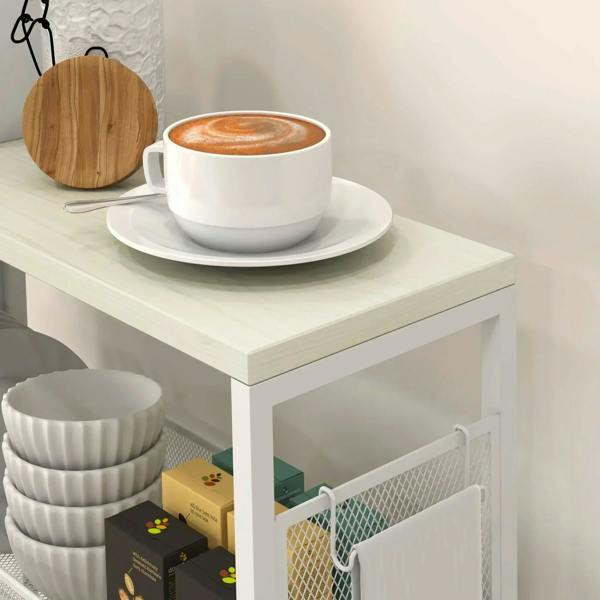 White 3-tier kitchen cart with wire basket and top surface holding a cup and saucer.