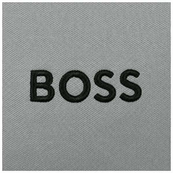 Close-up of a BOSS Paddy Pro polo shirt featuring black embroidered BOSS logo lettering on a textured medium grey fabric.