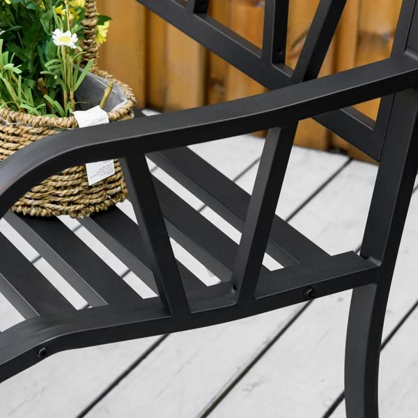 Black metal loveseat bench armrest with slatted design beside potted flowers