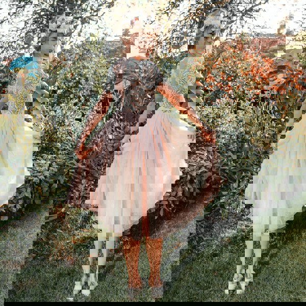 girl wearing bohemian flutter tea dress for uk flower girl boutique