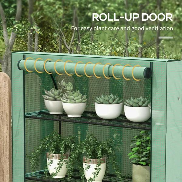 Green mini greenhouse with roll-up door and four wire shelves, potted plants inside