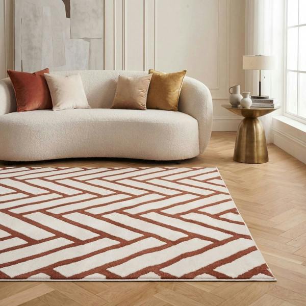 Modern living room with a patterned rug, sofa, and side table.