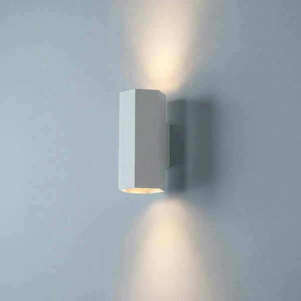 White interior up and down wall light on  a pale blue coloured wall
