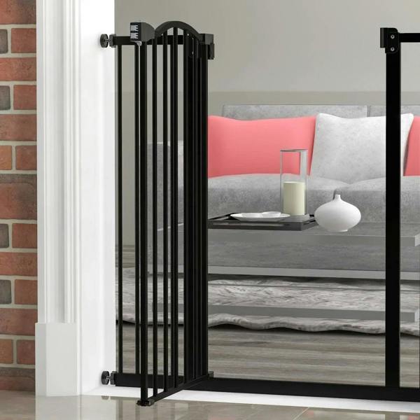 Black pressure-fit dog stair gate with arched top rail and vertical bars in doorway