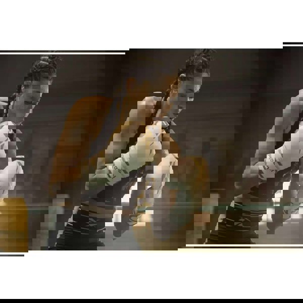 Woman boxing training wearing Reebok Boxing Gloves - White and Gold 