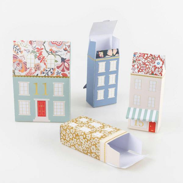Close-up of open Liberty floral print paper advent calendar boxes demonstrating how treats and gifts fit inside.