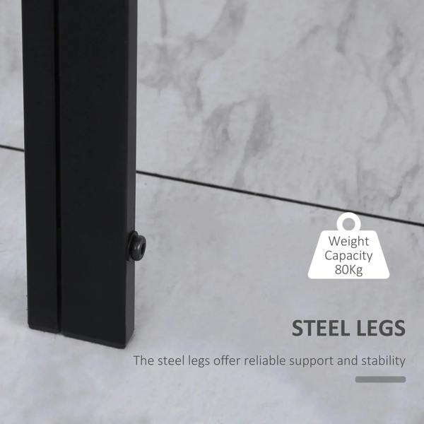 Black steel legs under a dining table with tempered glass top