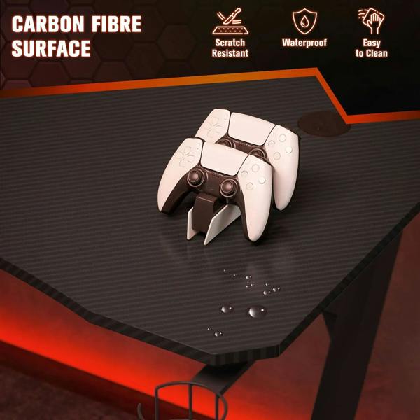 Black tabletop of gaming desk with non-slip texture and controller on surface