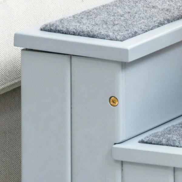 Side view of gray pet stairs with gold handle and carpeted step