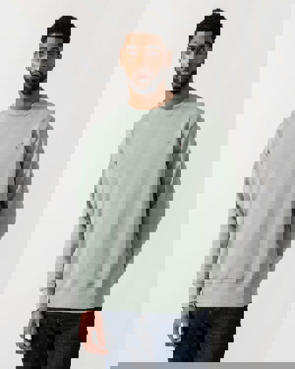 Model wearing GANT Mens Regular Fit Shield Logo Crew Neck Sweatshirt -in 10 Ceramic Grey - Main