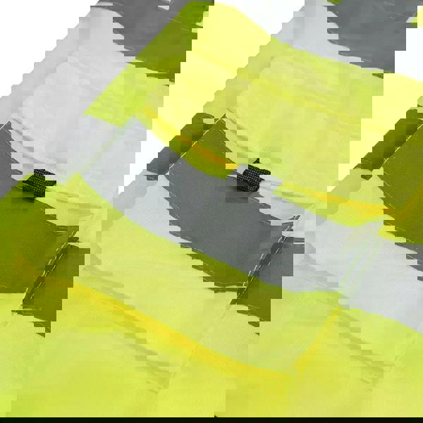 Scruffs High Visibility Mens Hi-Viz Technical Zip Up Vest, close-up of the bright yellow high-visibility safety vest with reflective grey bands and a zippered pocket.