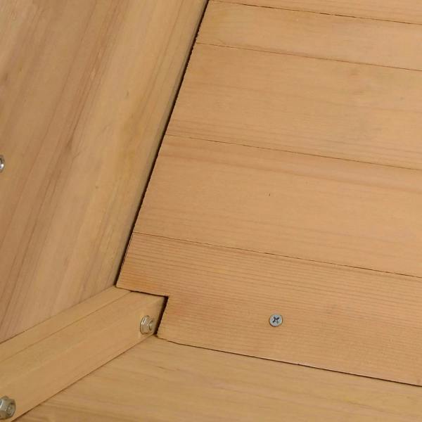 Corner close-up of a wooden raised planter bed with metal screws and joinery.