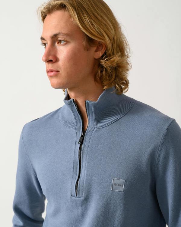 close up of model wearing a BOSS Orange Kanobix S Mens 1/4 Zip Jumper in Medium Blue 424